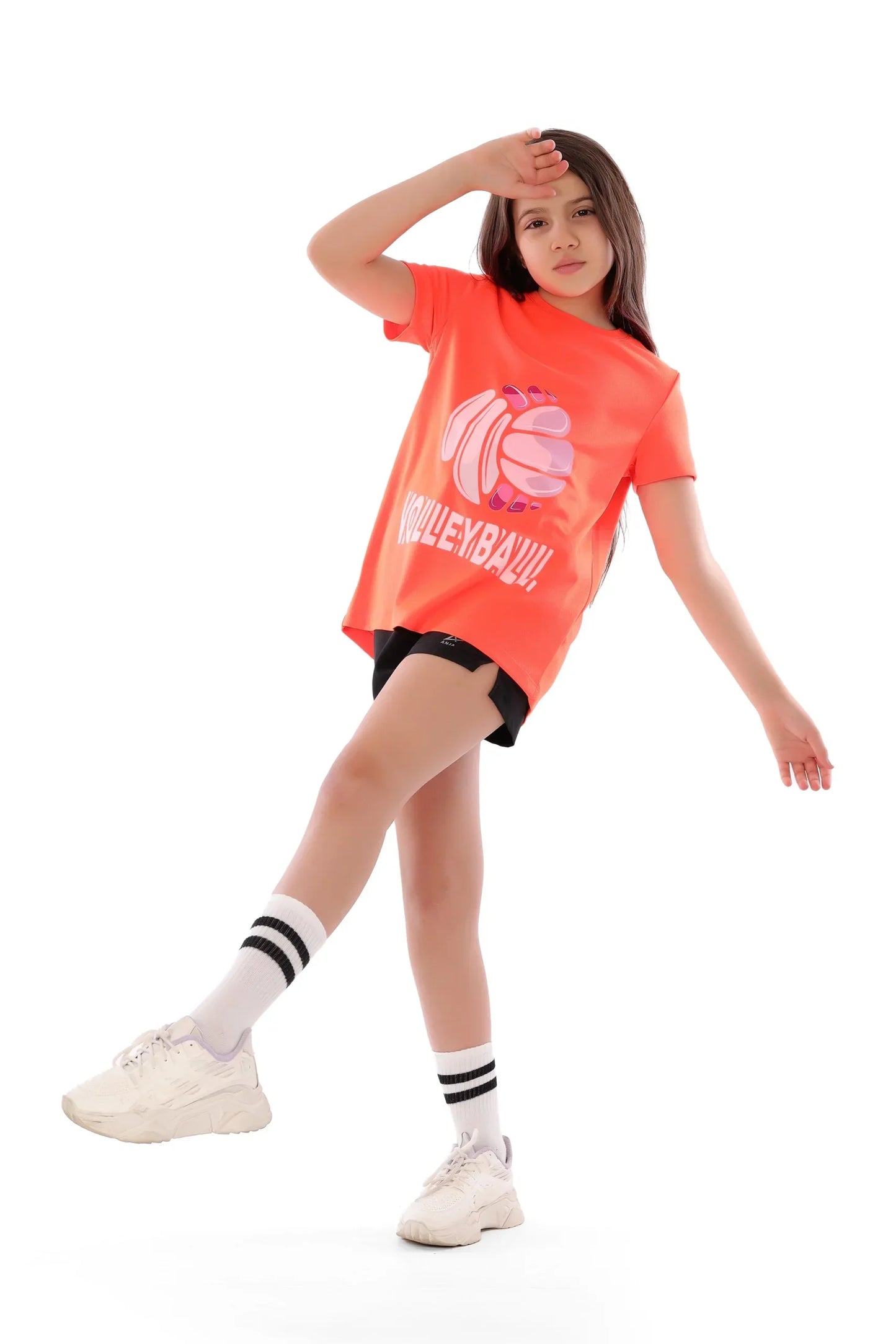 Child wearing a bright orange 'Volleyball' t-shirt on a white background