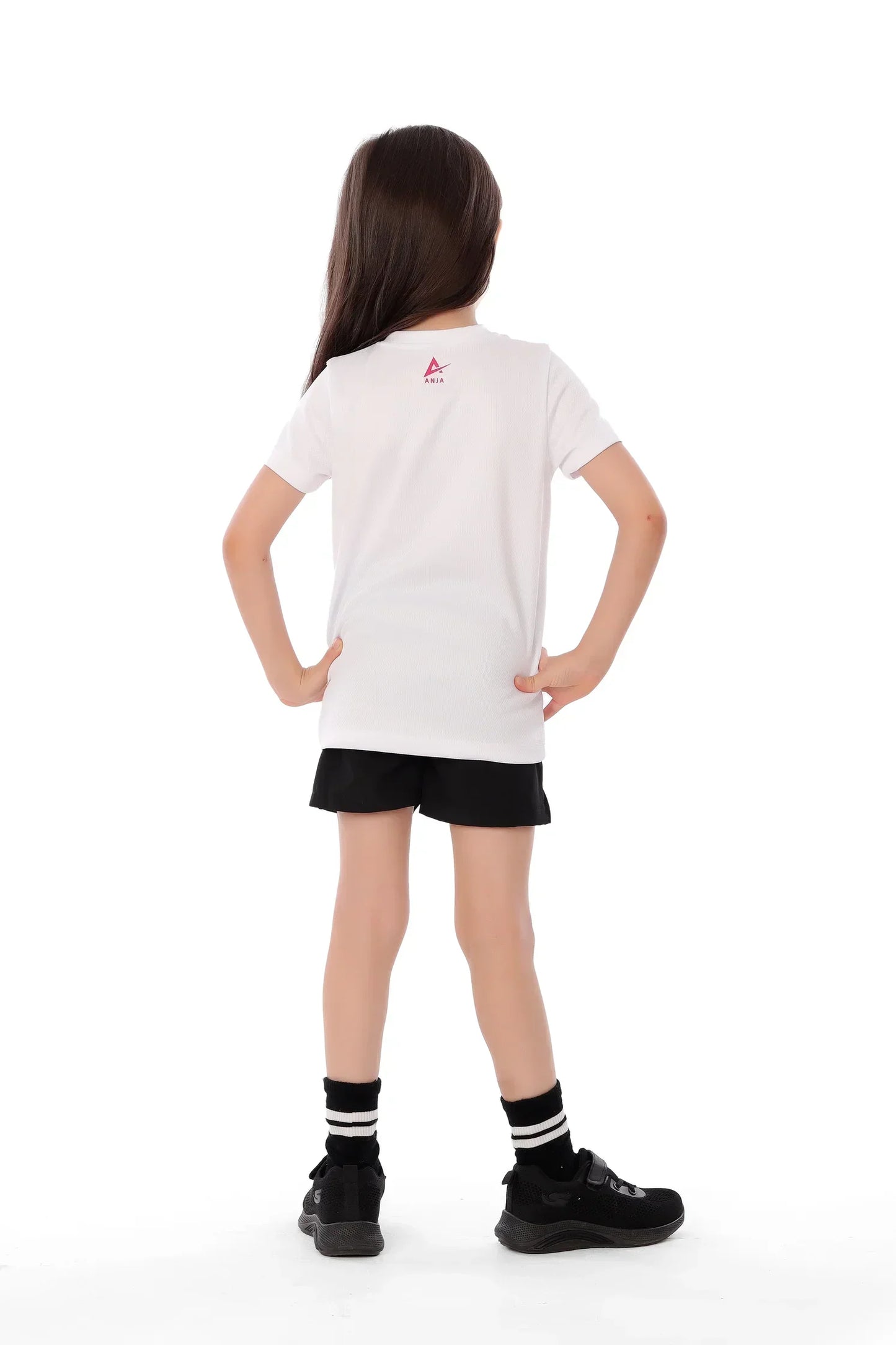 Person wearing a white t-shirt with a logo on the back, black shorts, and black shoes on a white background