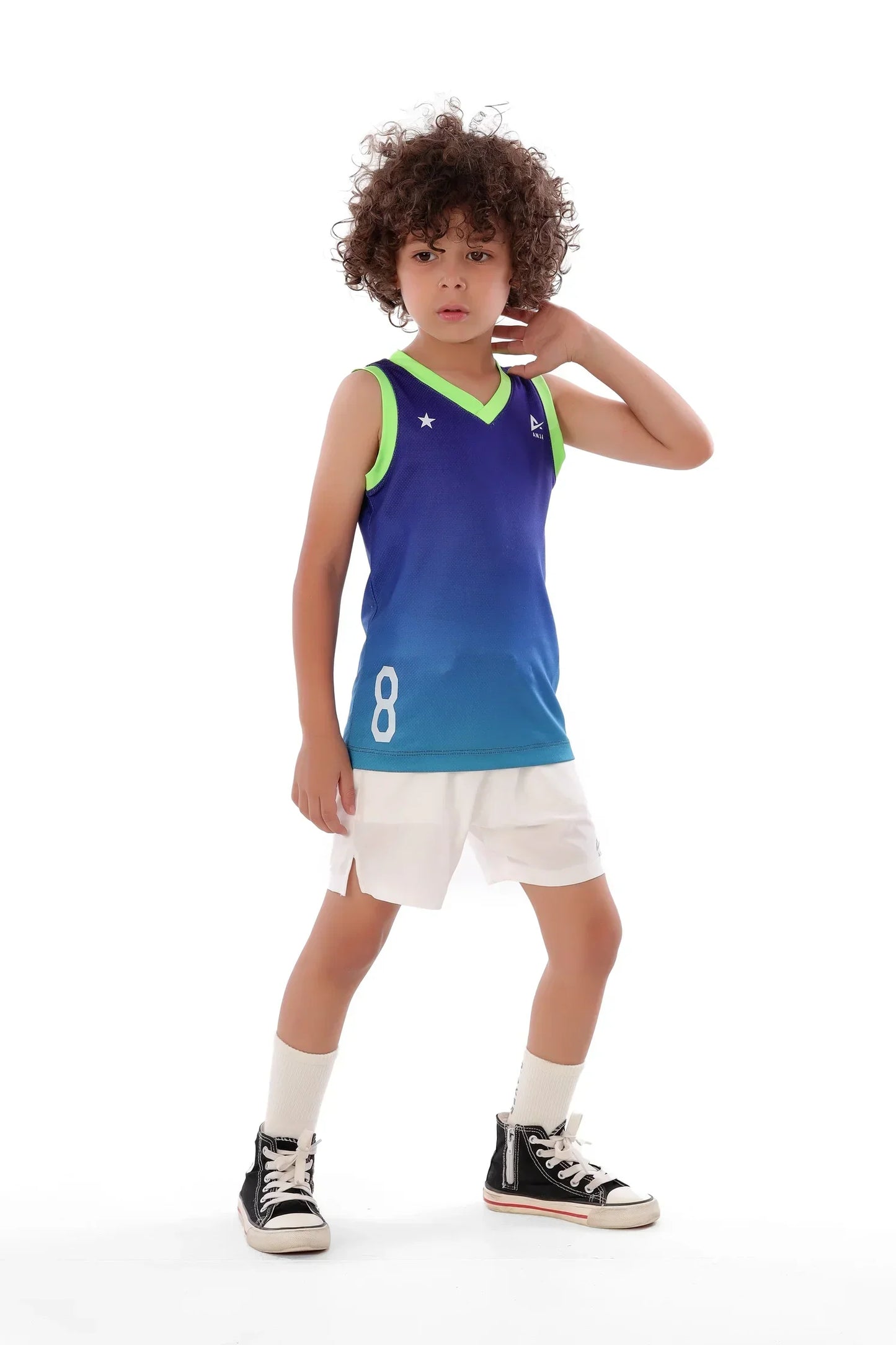 Child wearing a blue sleeveless jersey with green accents and white shorts on a white background