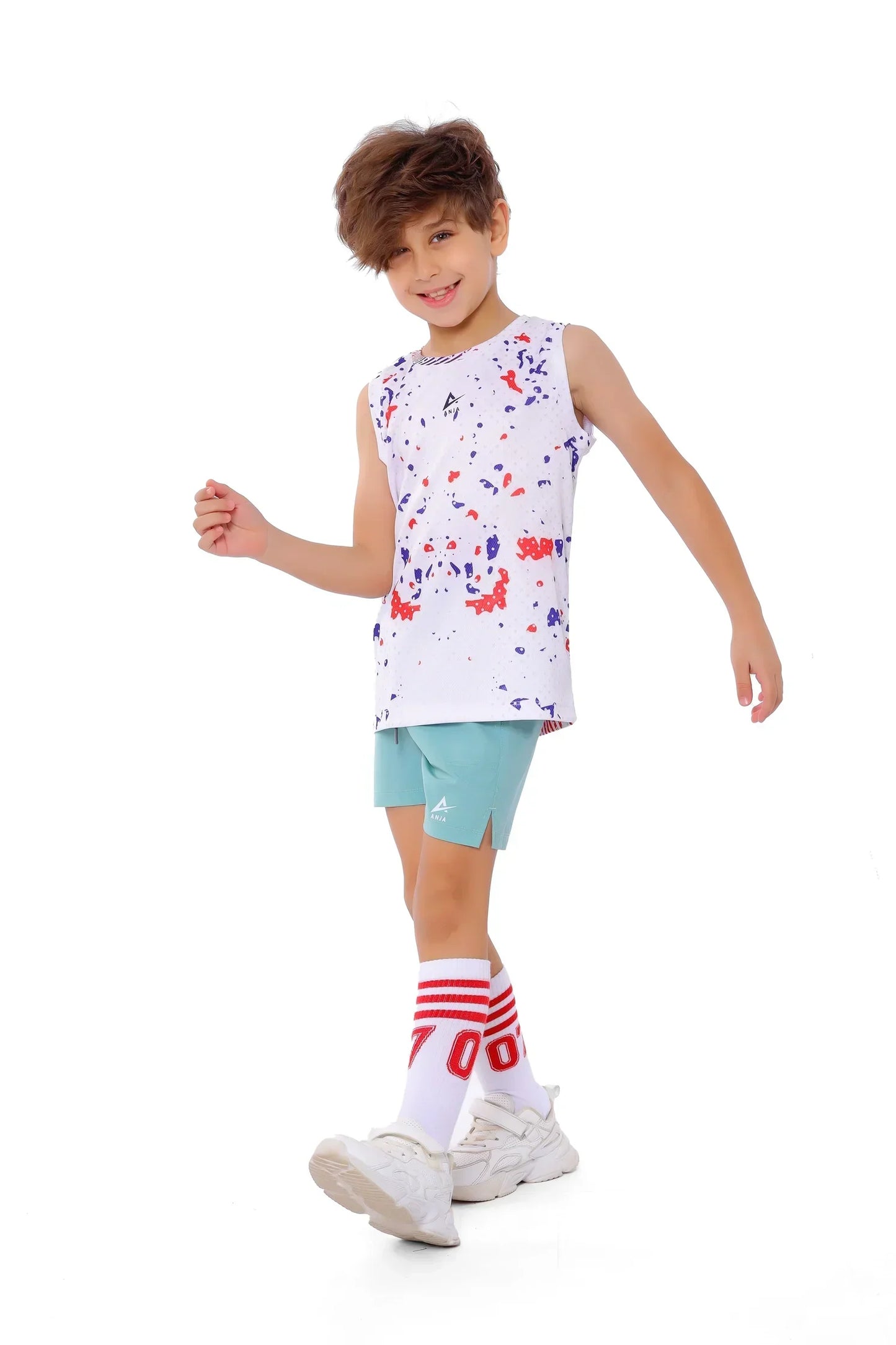 Child wearing a colorful sleeveless shirt and light blue shorts on a white background