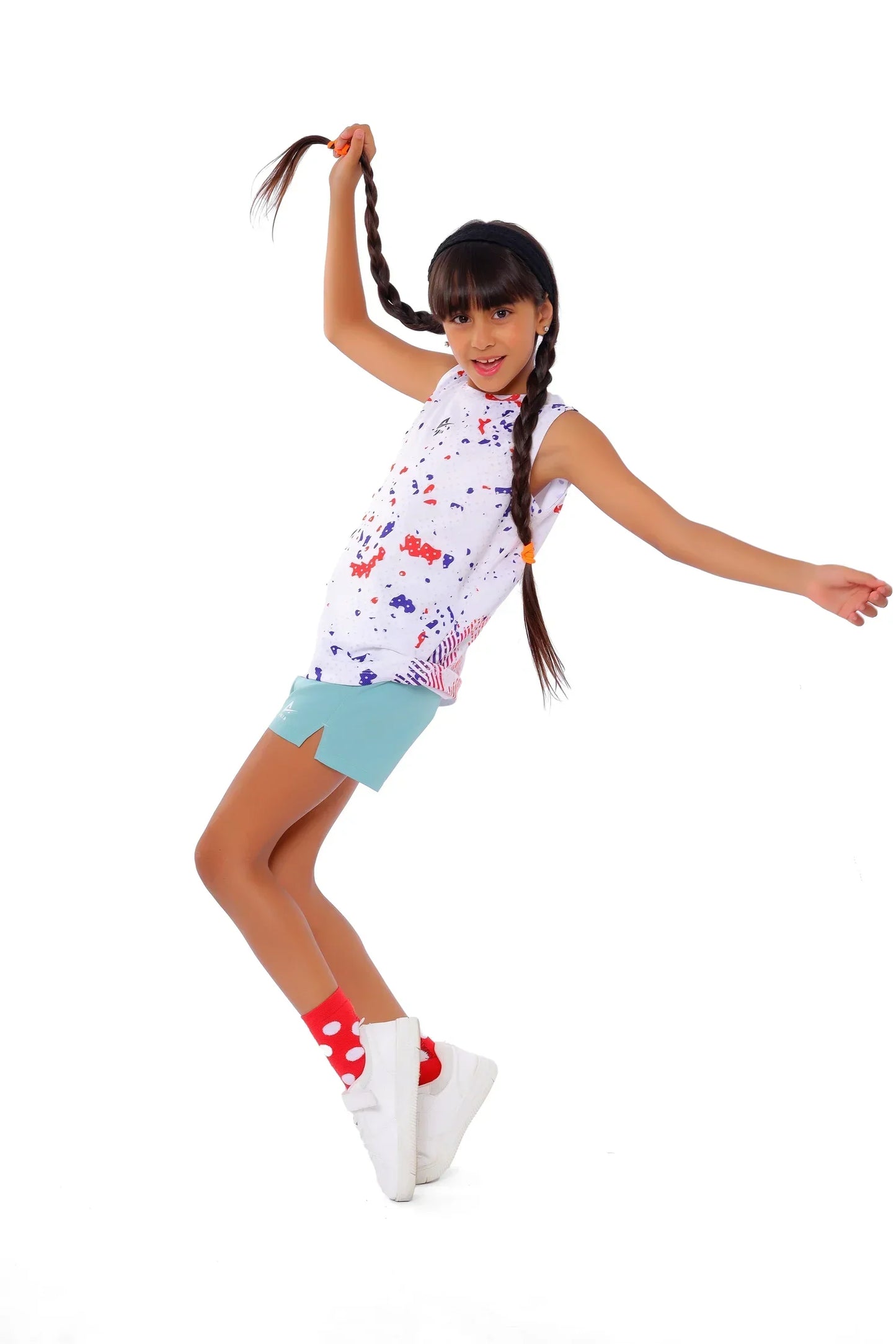 Young girl in a colorful outfit with a white background
