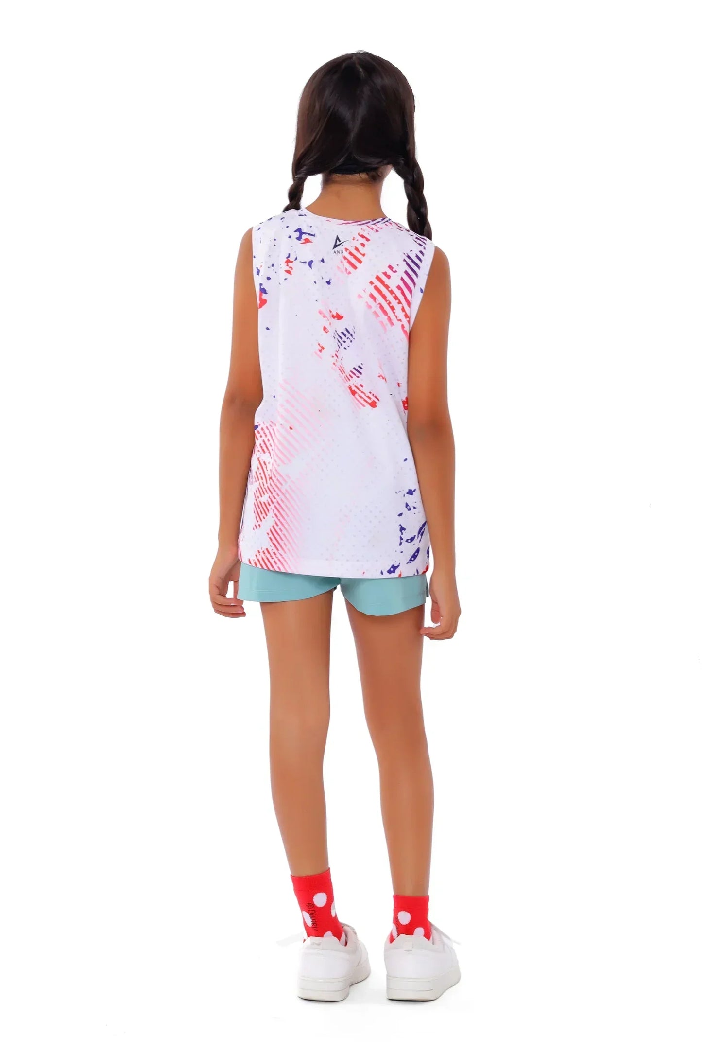 Girl wearing a sleeveless top with colorful abstract design on a white background