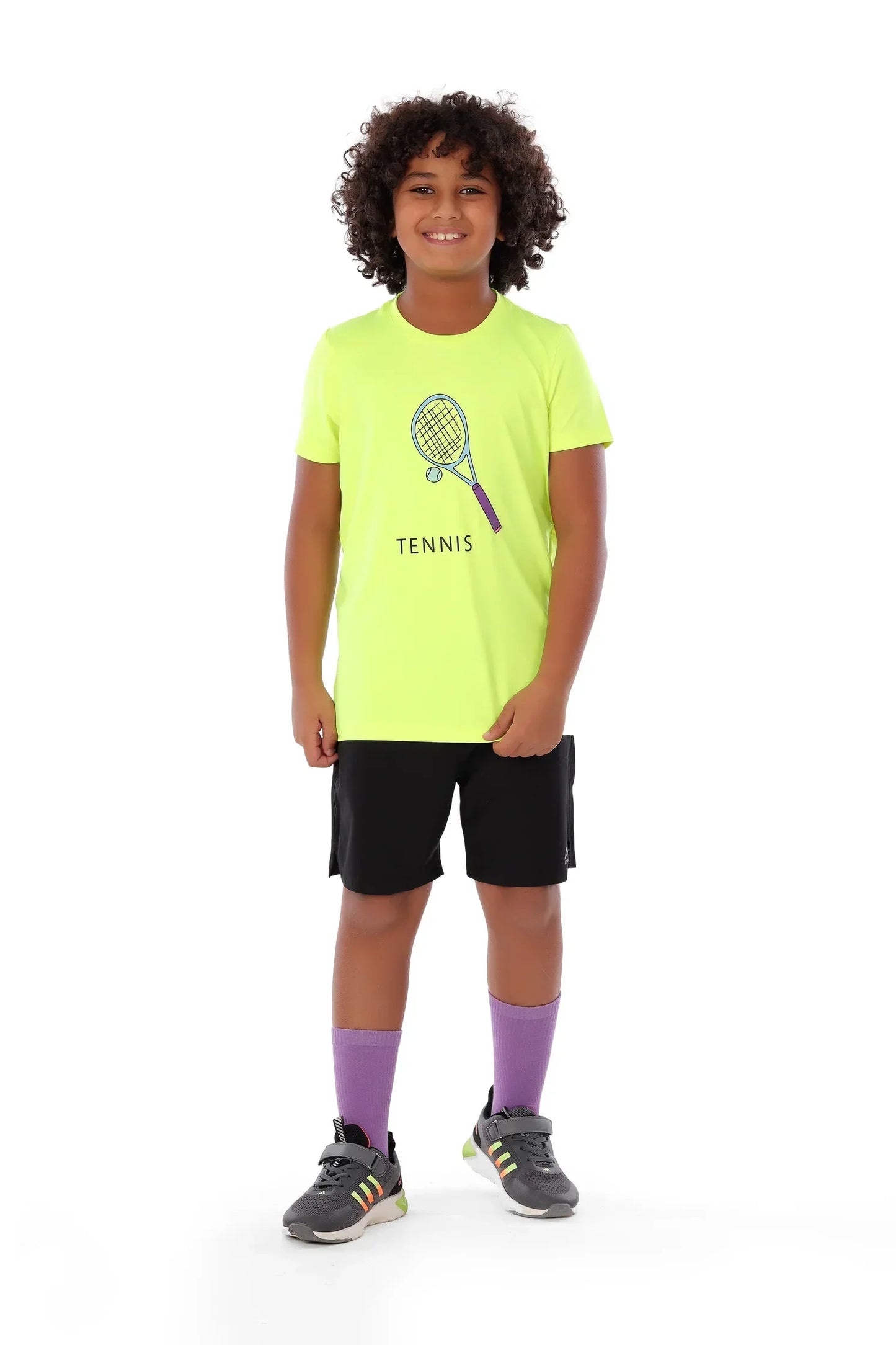 Child wearing a bright yellow tennis-themed t-shirt on a white background
