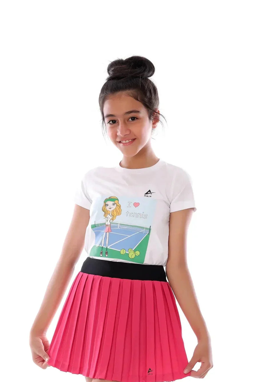 Young girl wearing a white t-shirt with a graphic design and a pink skirt on a white background