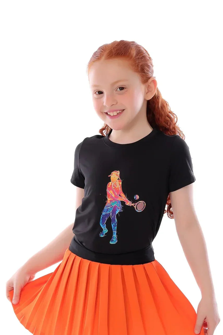 Young girl wearing a black t-shirt with a colorful graphic design and an orange pleated skirt on a white background