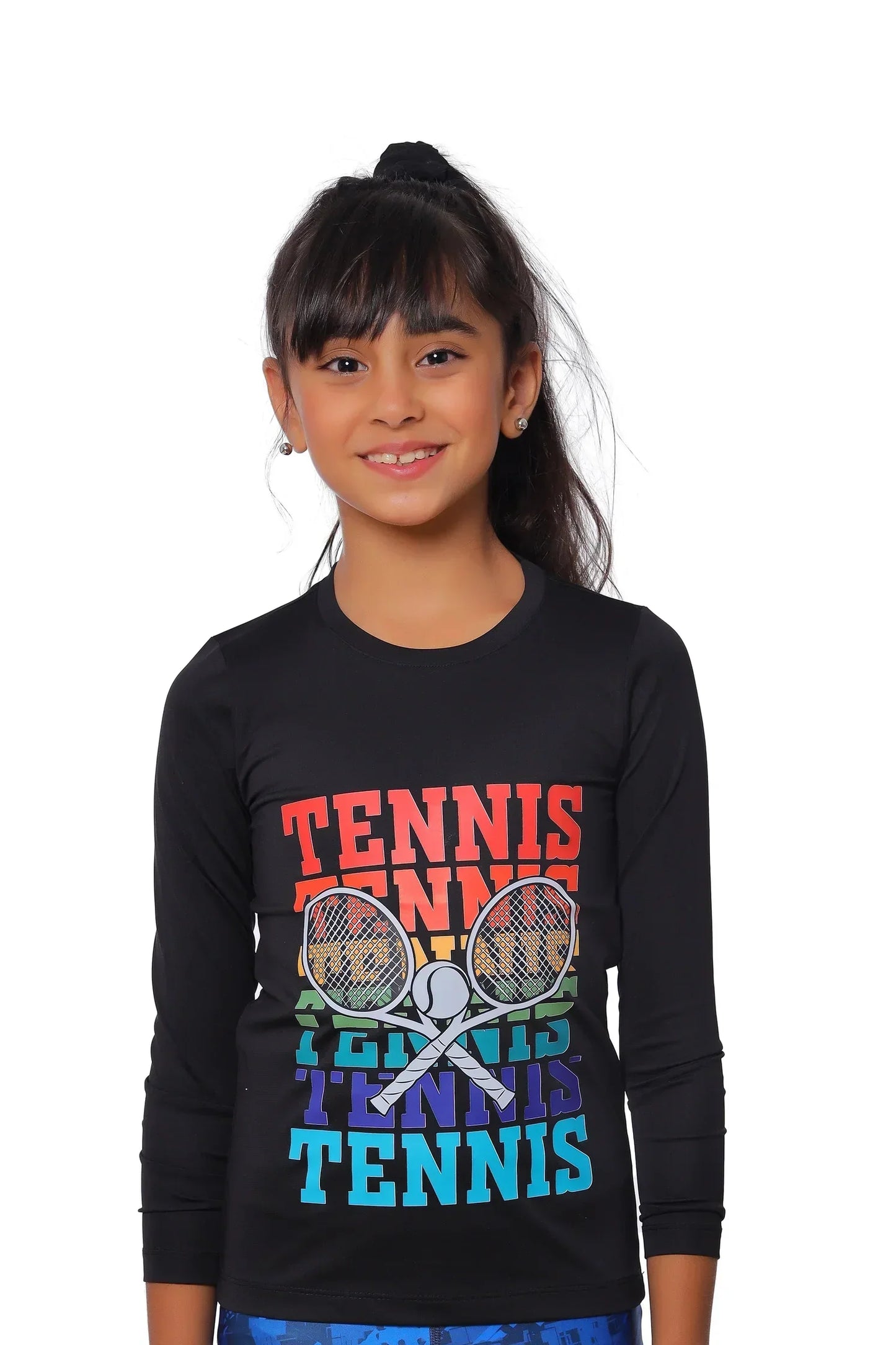 Young girl wearing a black long-sleeve shirt with colorful tennis graphics on a white background