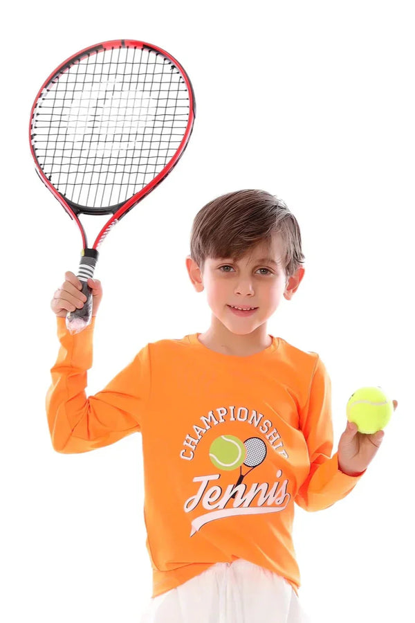 Child holding a tennis racket and ball, wearing an orange 'Championship Tennis' shirt on a white background