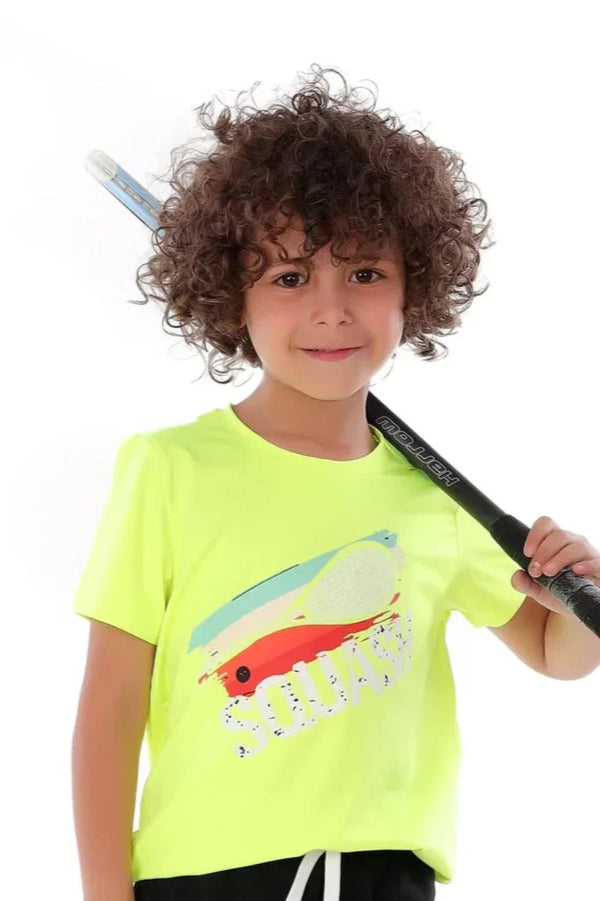 Child wearing a bright yellow t-shirt with a colorful design, holding a black object.