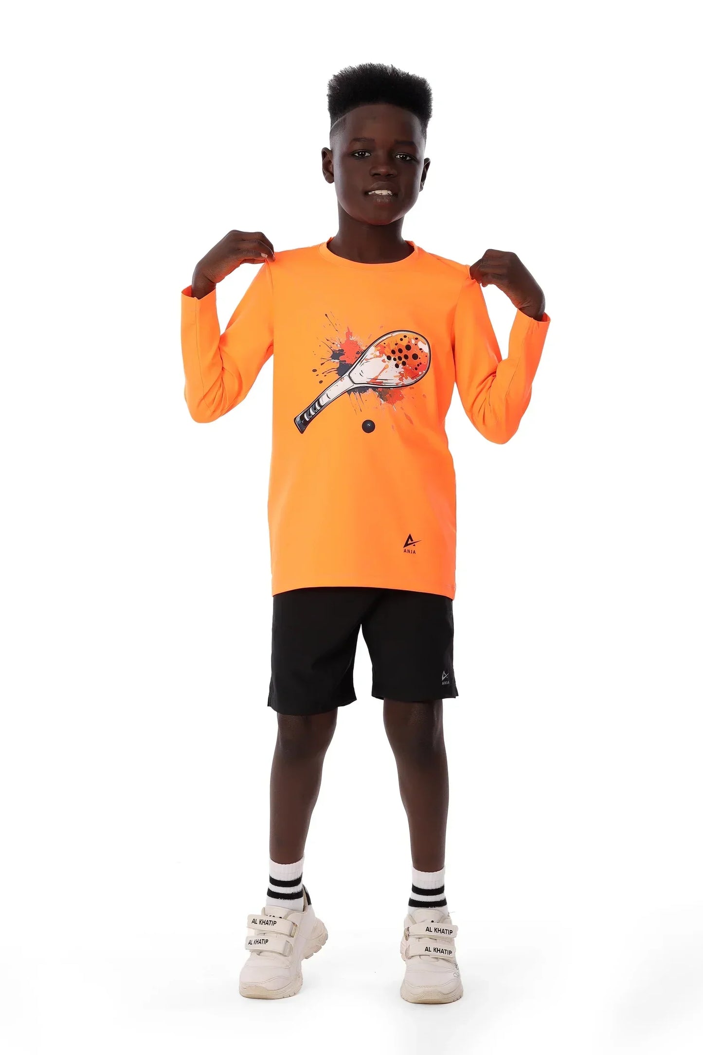 Child wearing an orange long-sleeve shirt with a graphic design on a white background