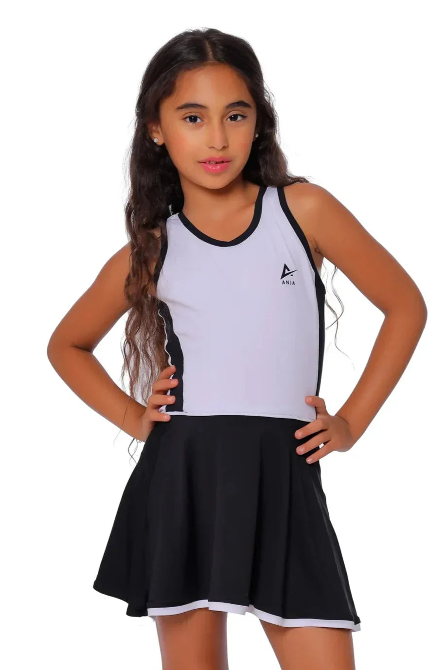 Young girl wearing a black and white dress with a logo on a white background