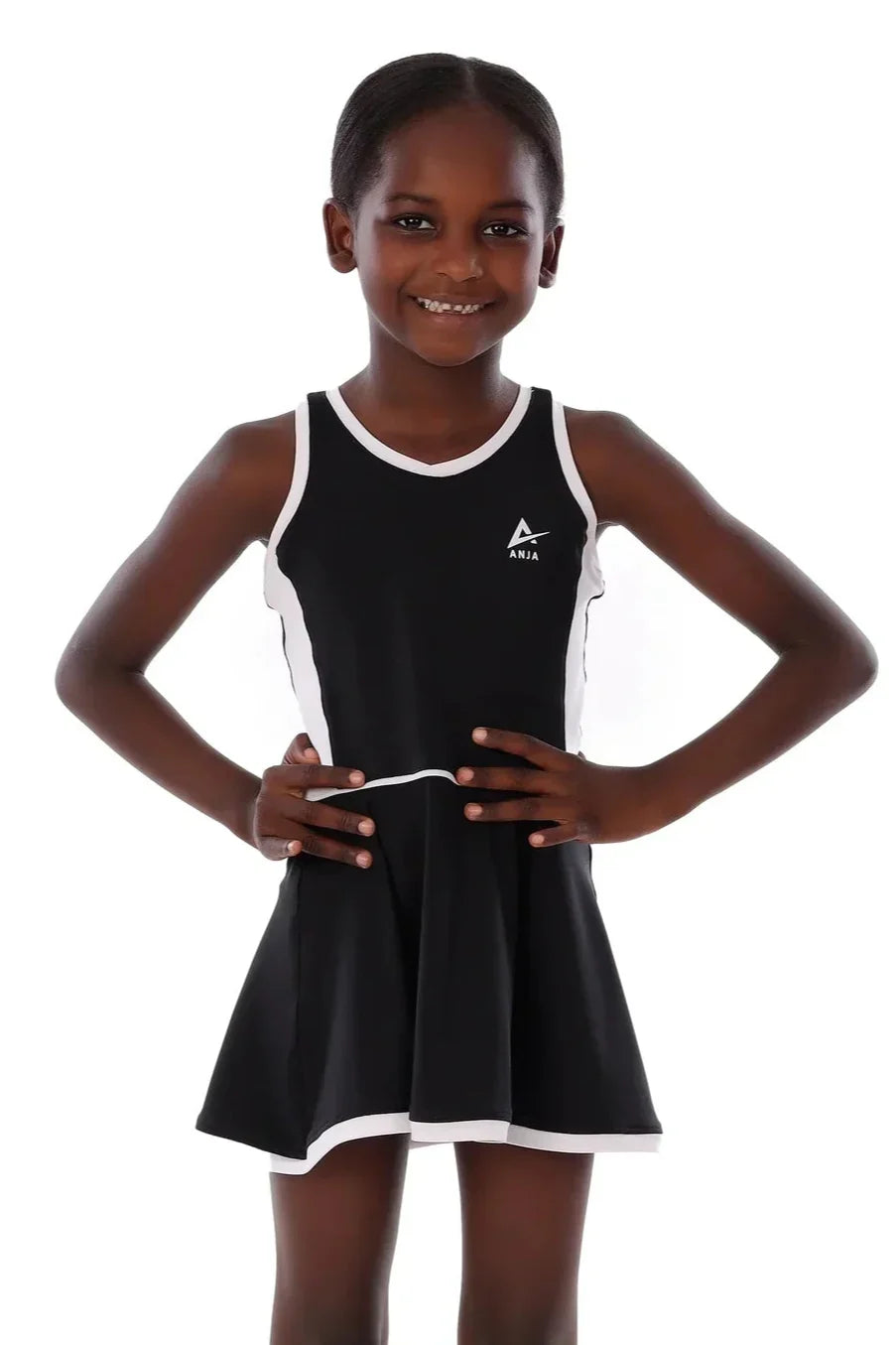 Young girl wearing a black and white dress with a logo on a white background