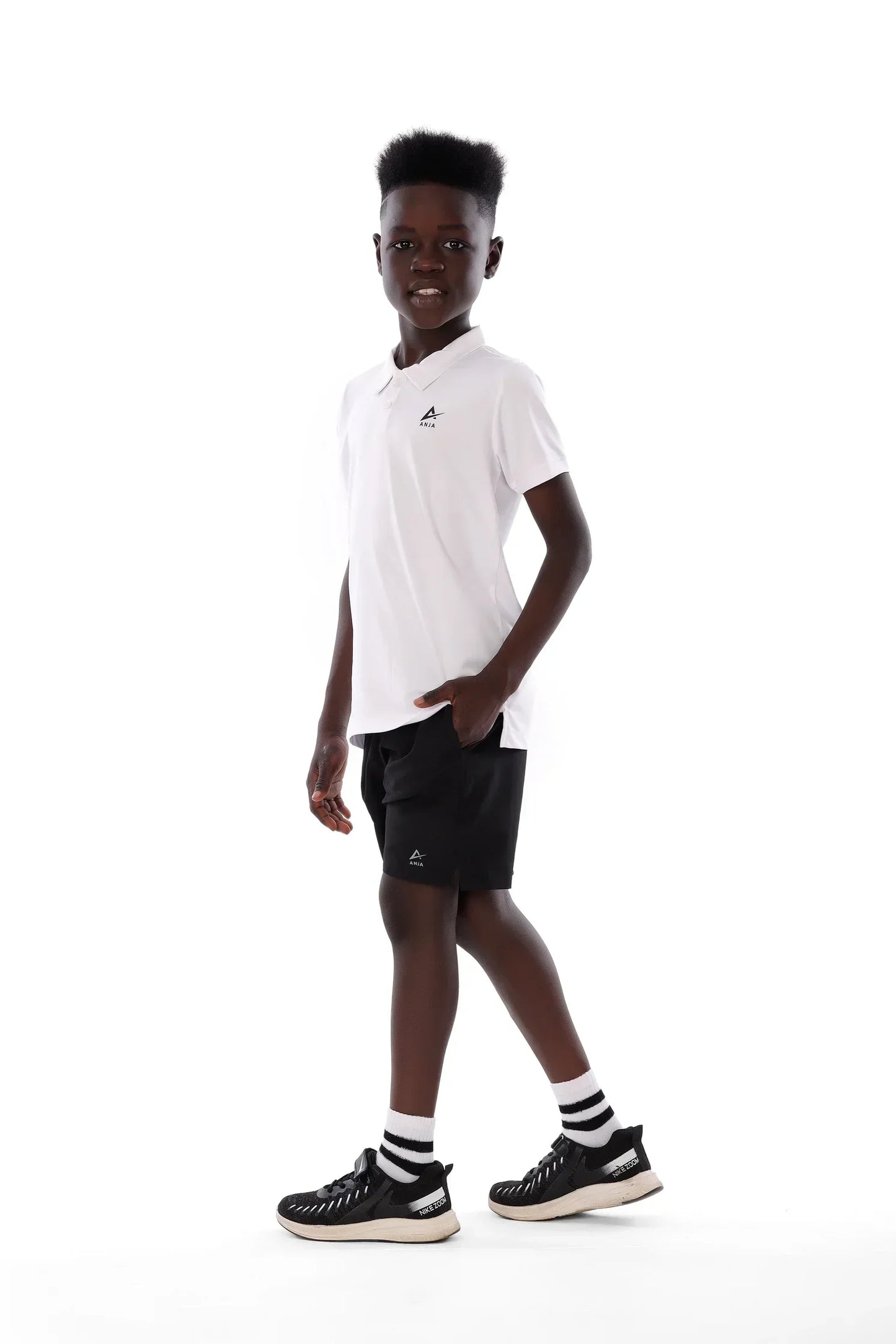 Person wearing a white t-shirt and black shorts with a brand logo on a white background