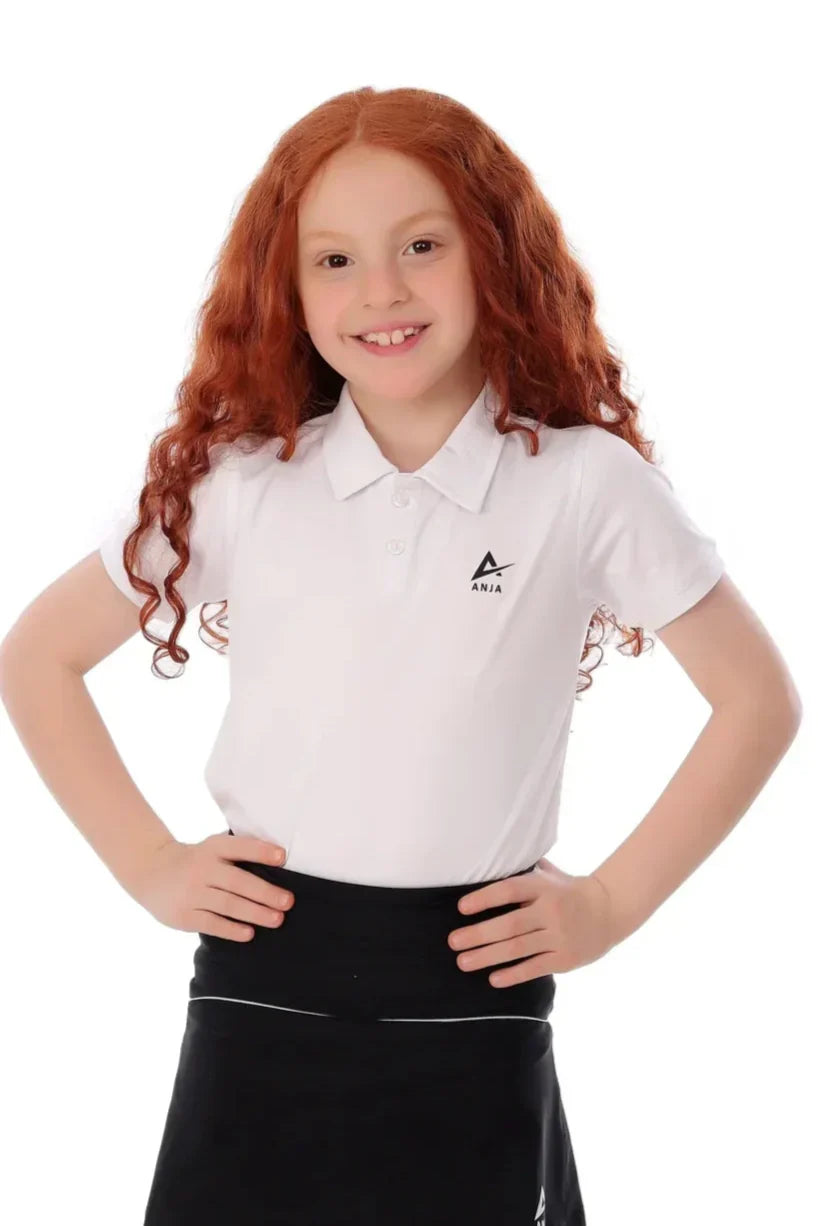 Young girl wearing a white polo shirt with a logo on a white background