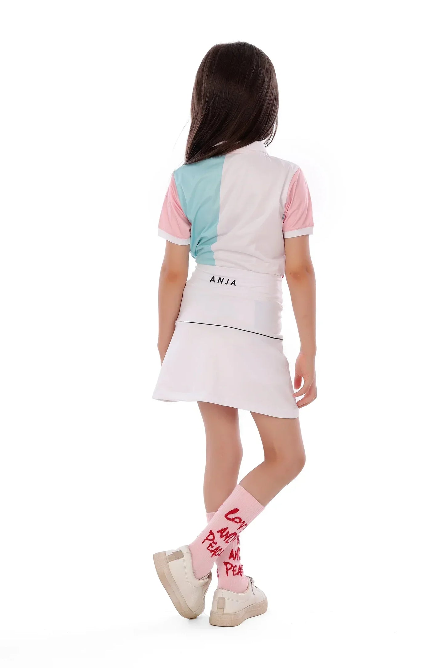 Girl wearing a colorful dress with 'ANIA' branding on a white background