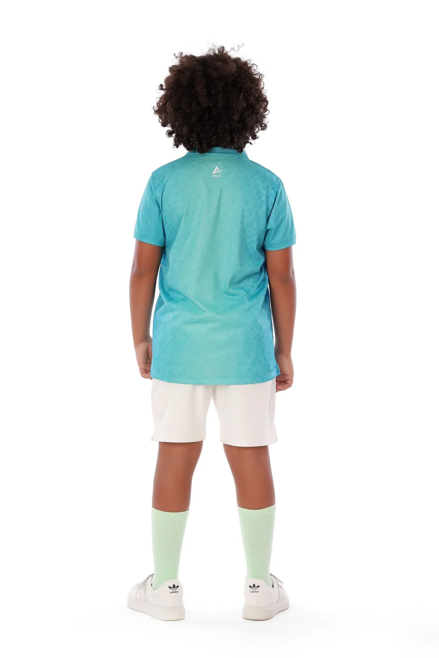 Person wearing a turquoise shirt and white shorts on a white background