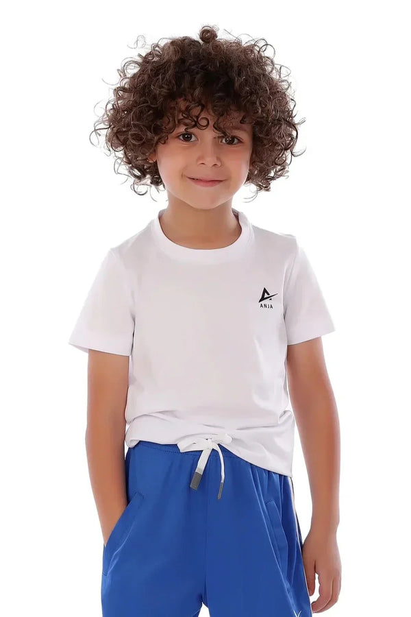 Child wearing a white t-shirt with a logo and blue shorts on a white background