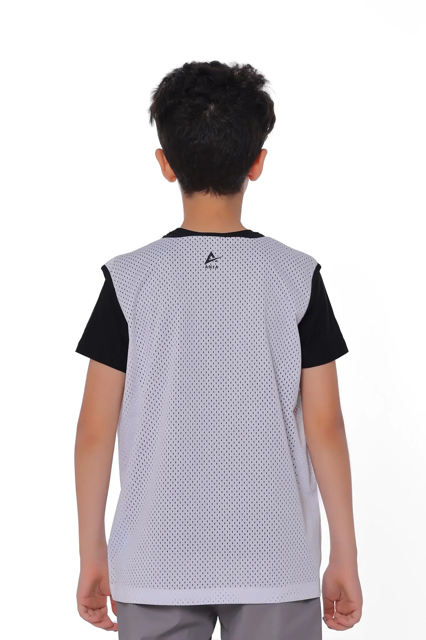 Person wearing a black and white sports jersey on a white background