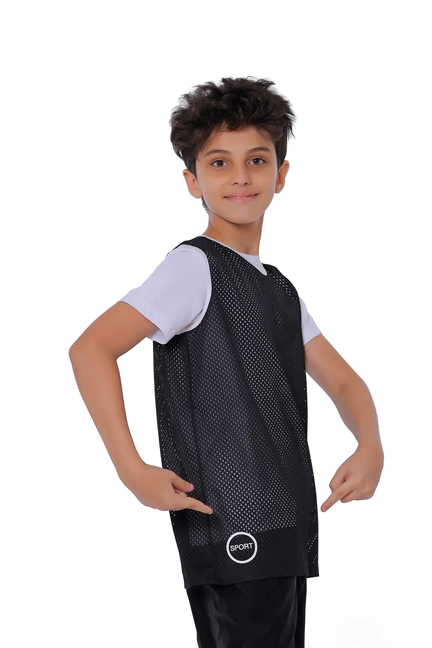 Child wearing a black sports jersey over a white shirt on a white background