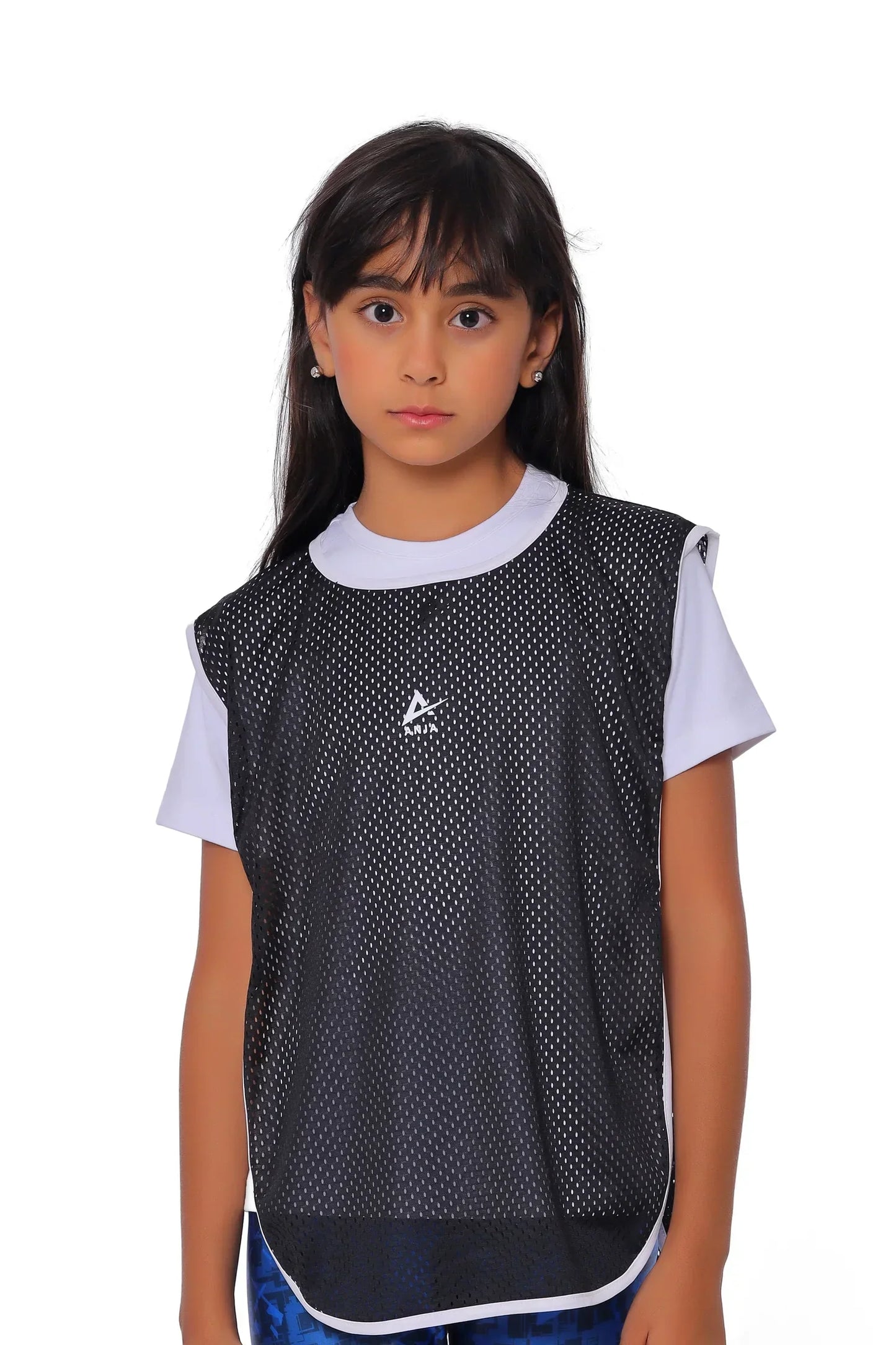Child wearing a black and white sports jersey on a white background