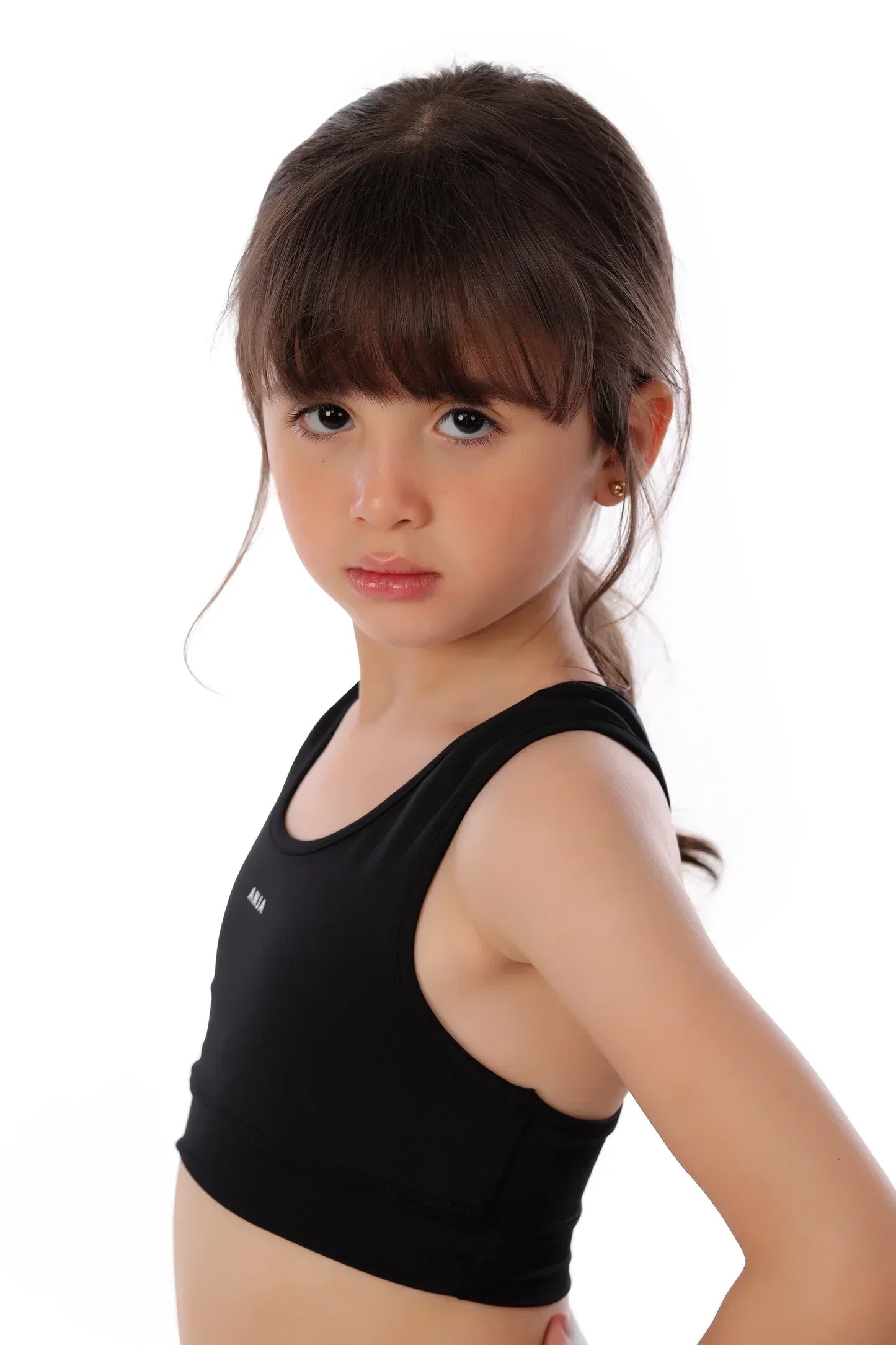 Young girl wearing a black tank top on a white background