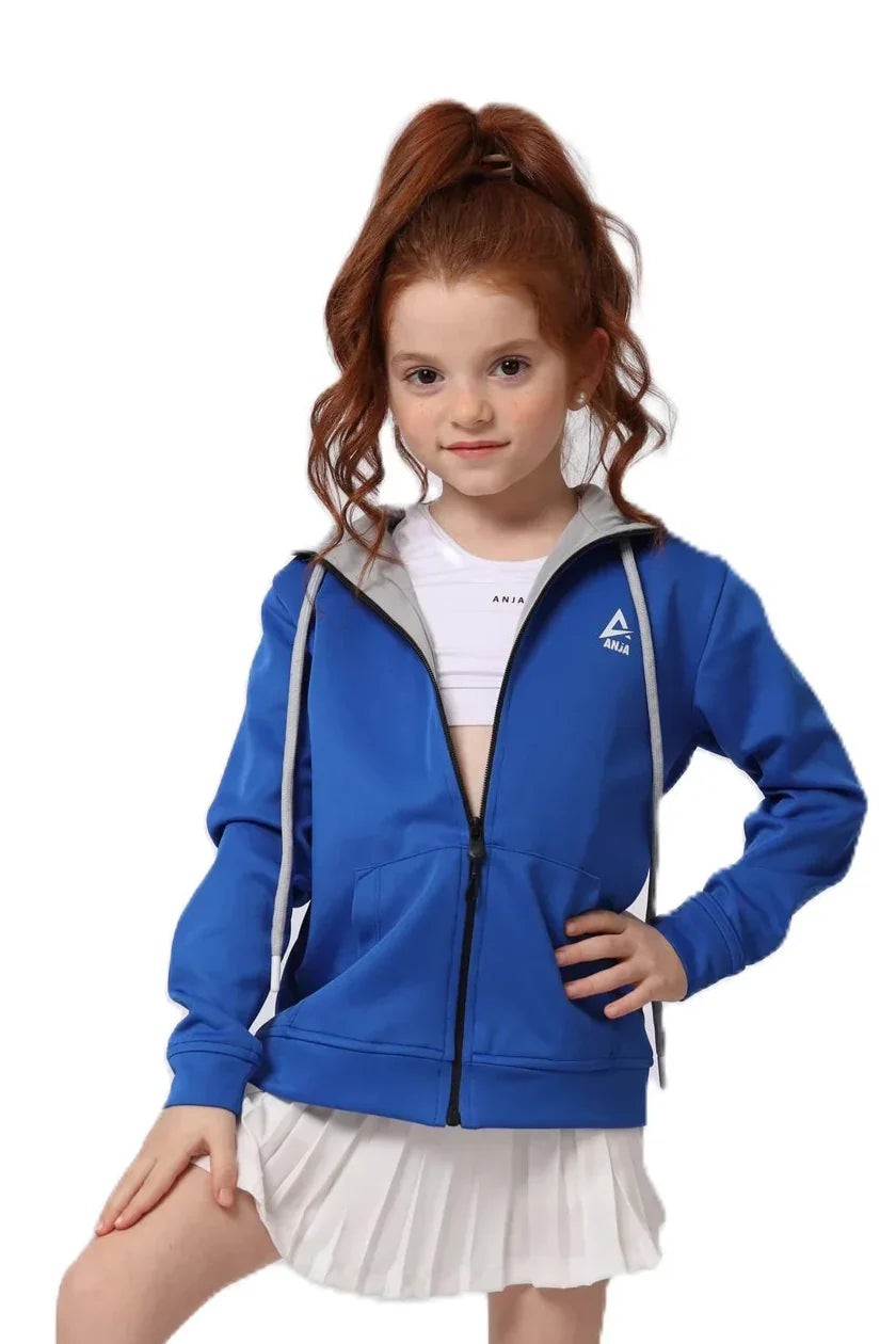 Young girl wearing a blue jacket with a brand logo on a white background