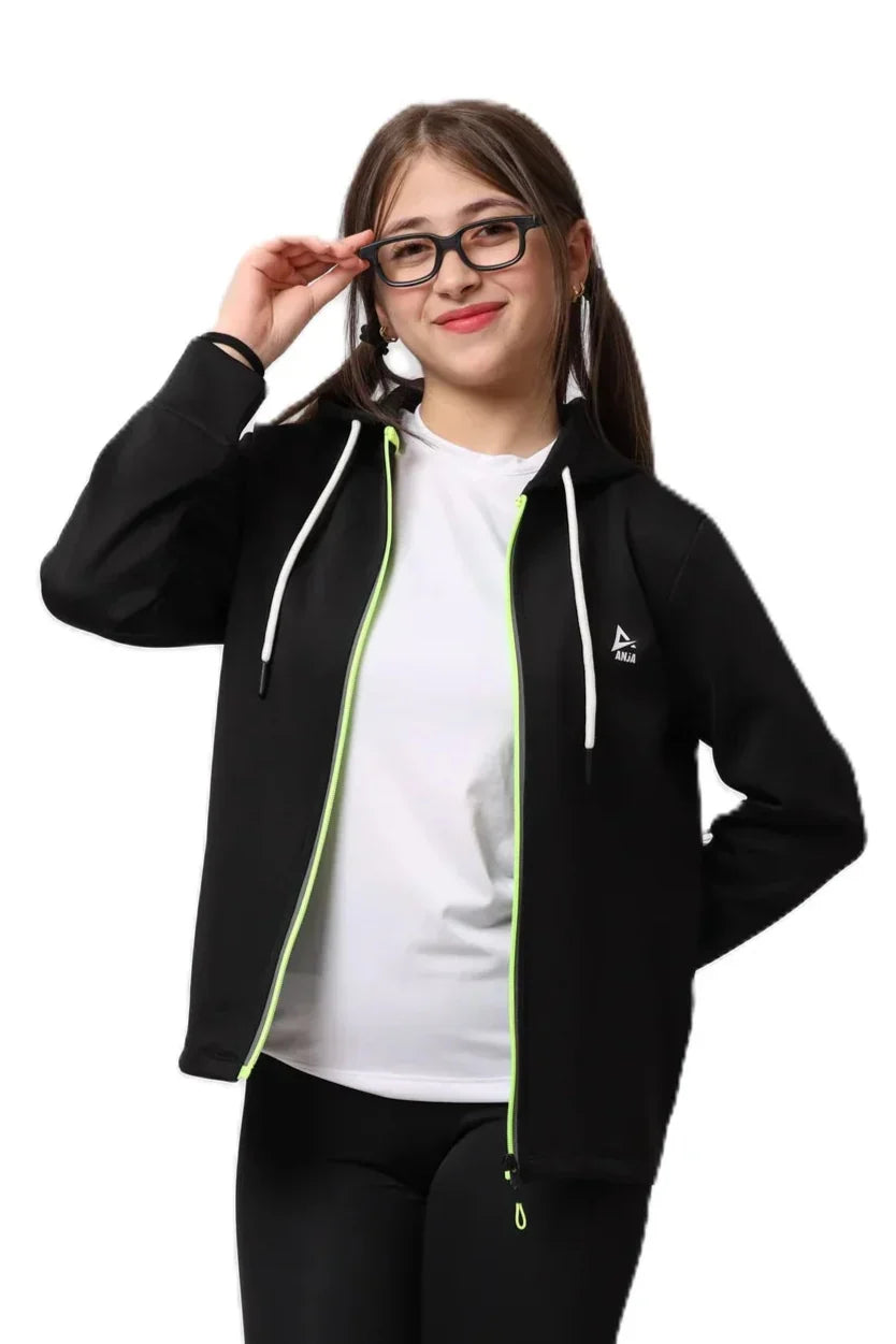 Person wearing a black hoodie with green accents and a white shirt underneath on a white background