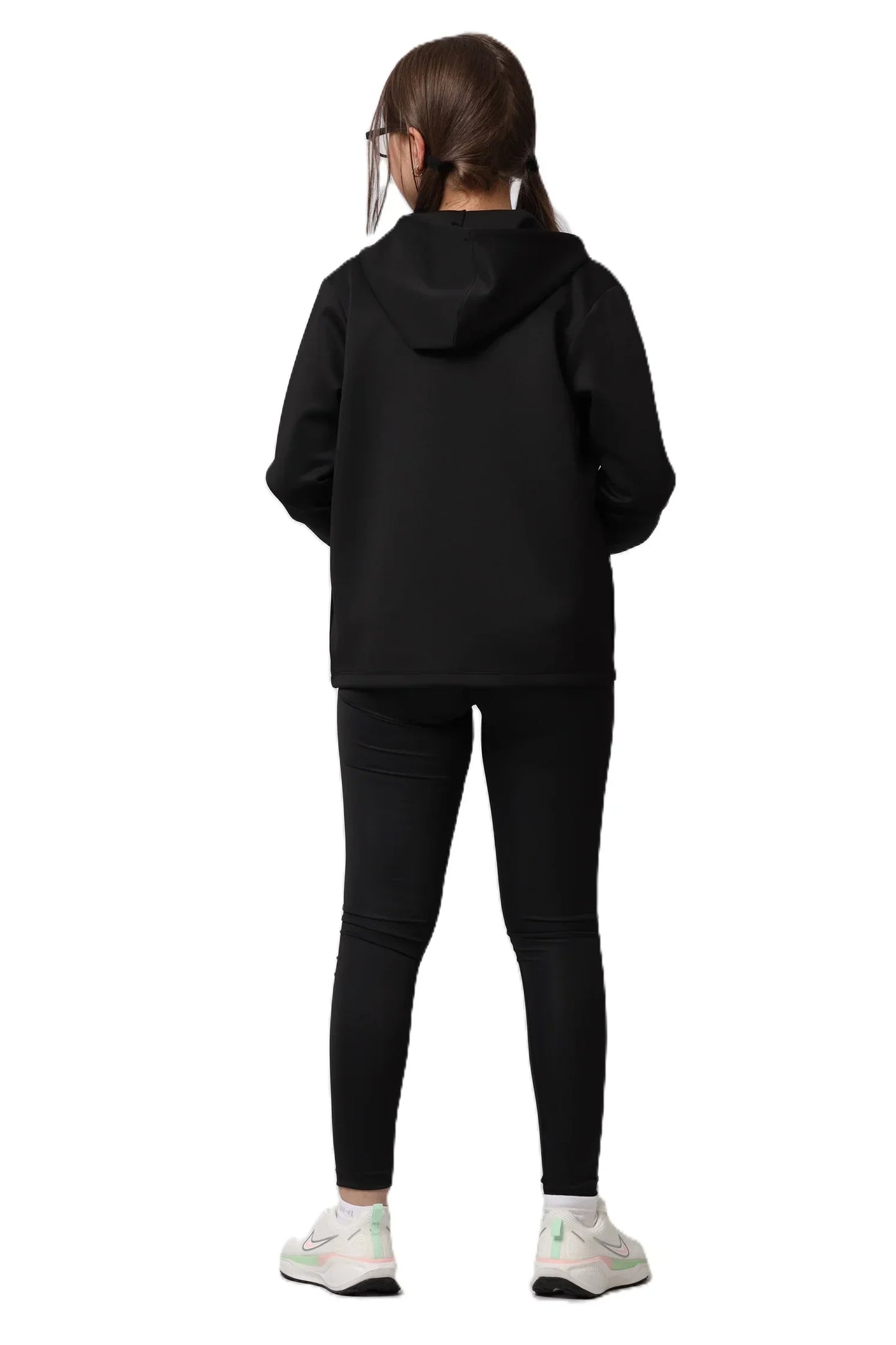 Person wearing a black hoodie and leggings on a white background
