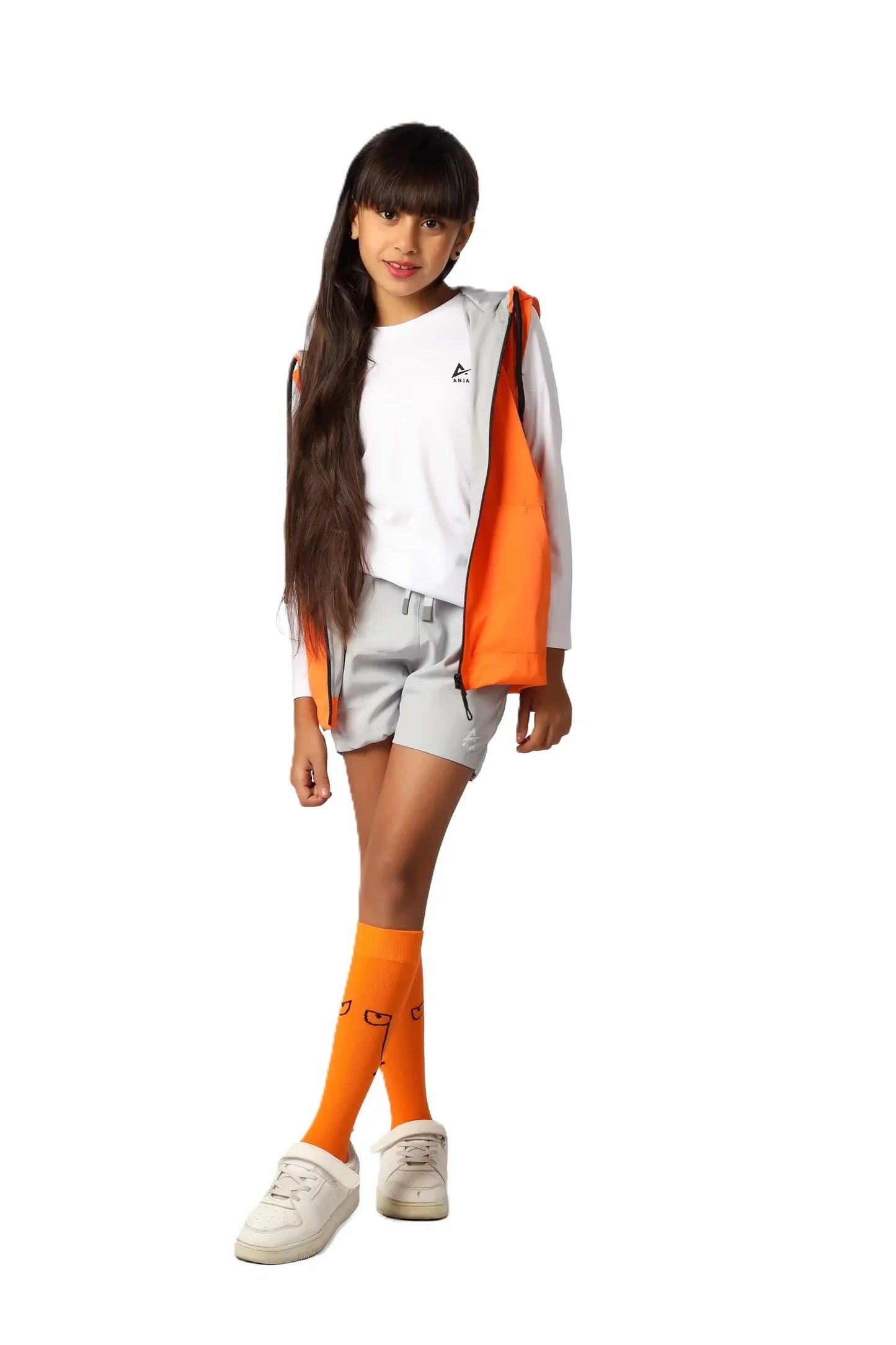 Person wearing a white and orange outfit with matching socks on a white background