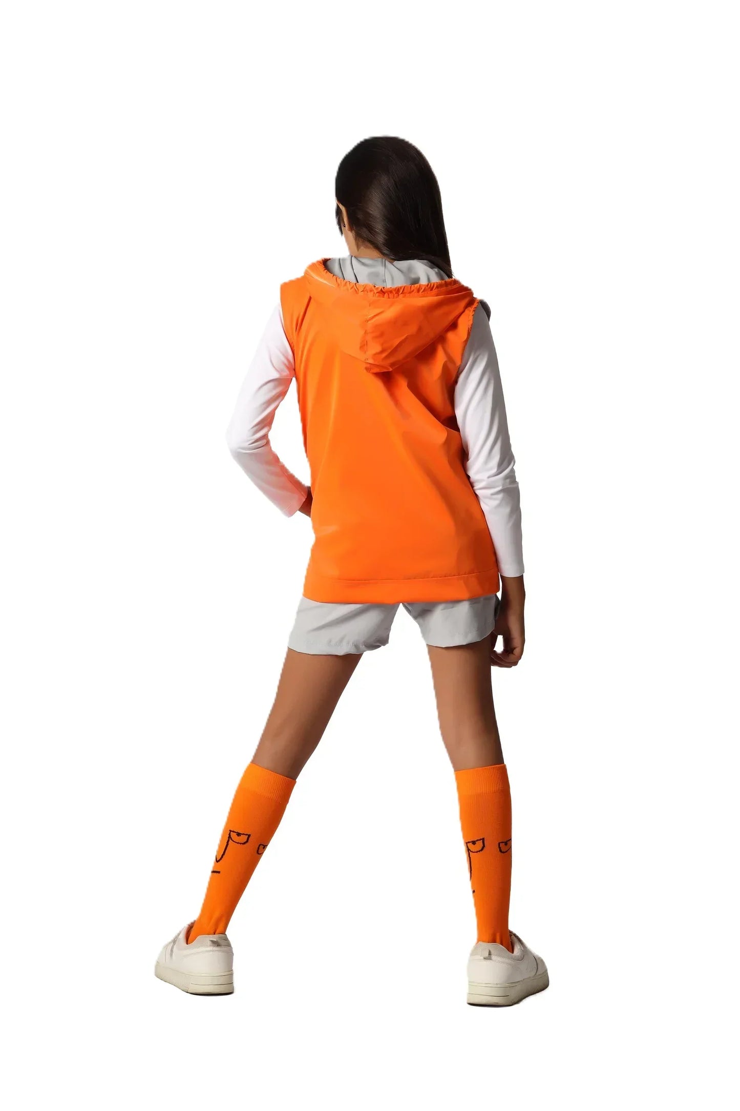 Person wearing an orange raincoat and white outfit with orange socks on a white background