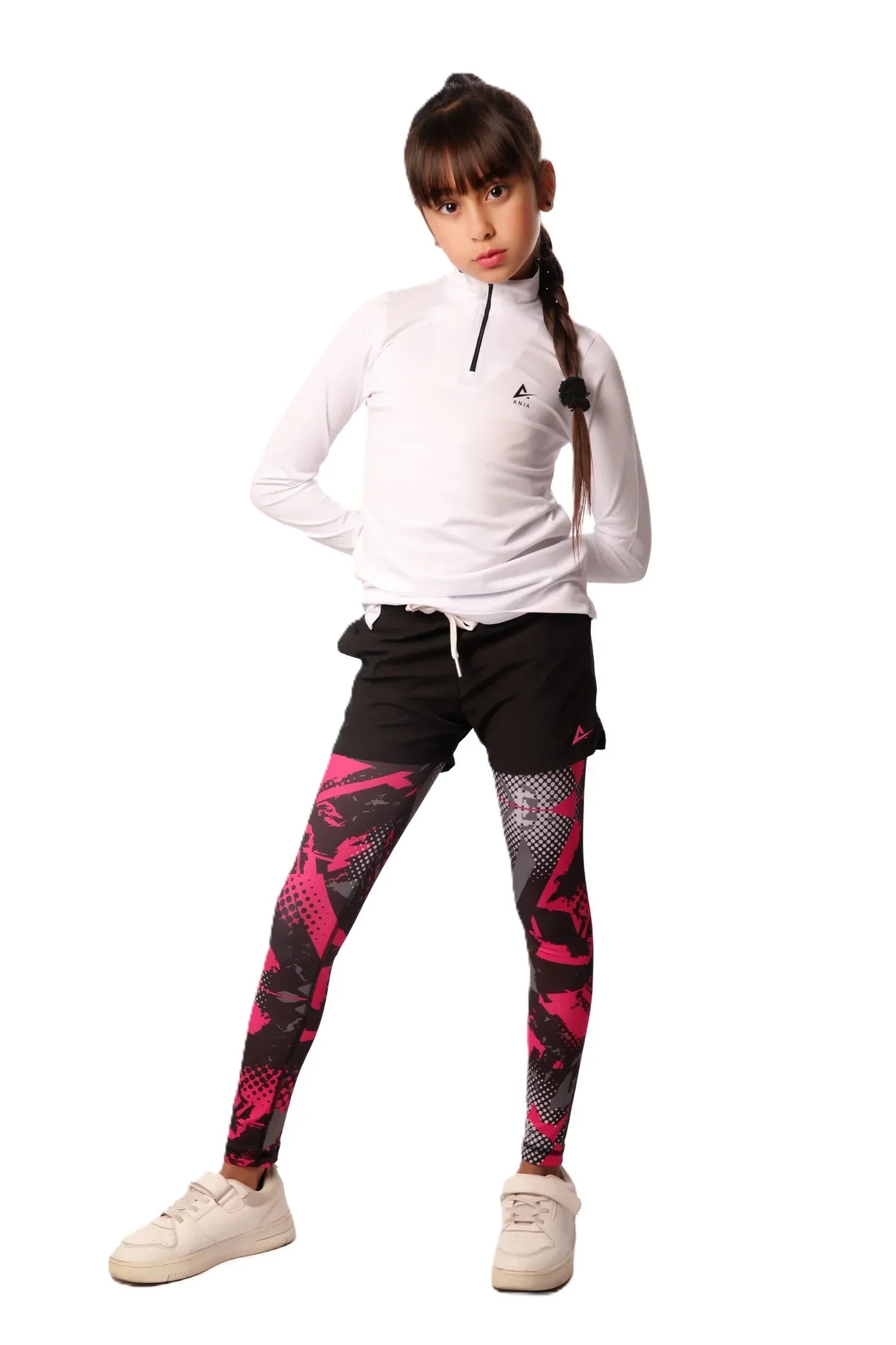 Child wearing a white hoodie and black leggings with pink designs on a white background