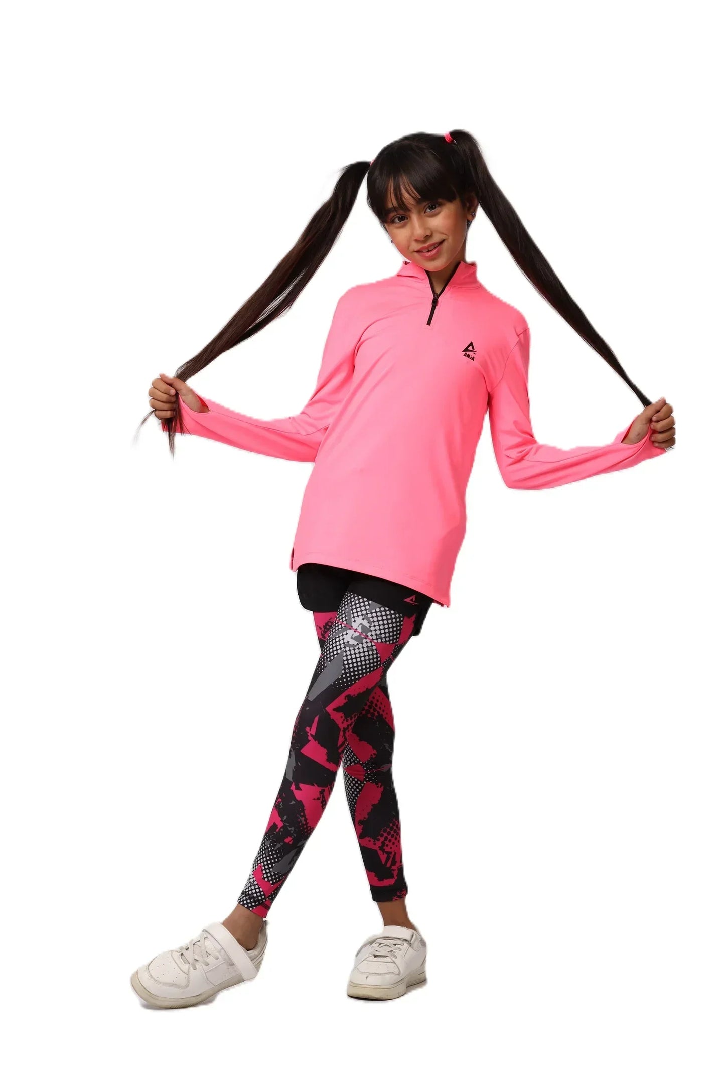 Child wearing a pink long-sleeve top and patterned leggings on a white background
