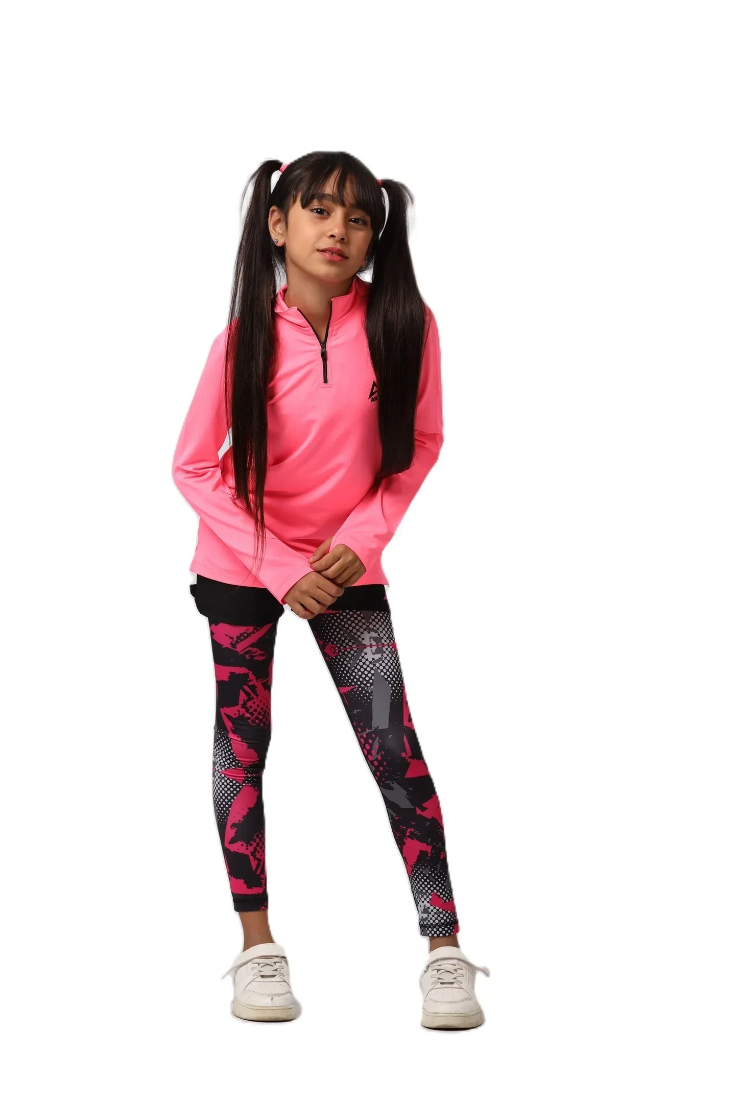 Child wearing a pink long-sleeve top and black leggings with red patterns on a white background