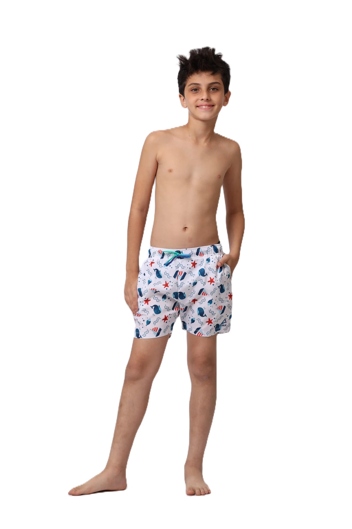 Young boy wearing patterned shorts on a white background