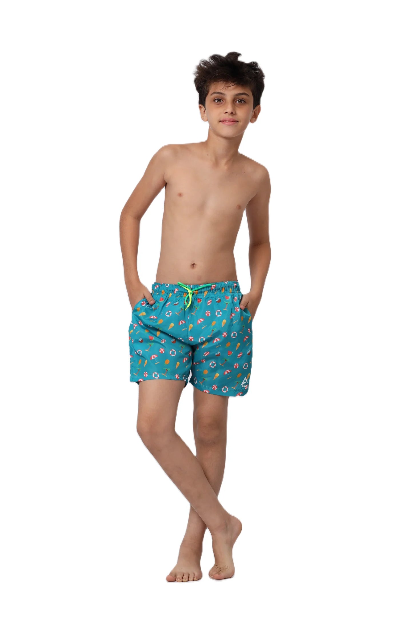 Young boy wearing blue swim shorts with a pattern on a white background