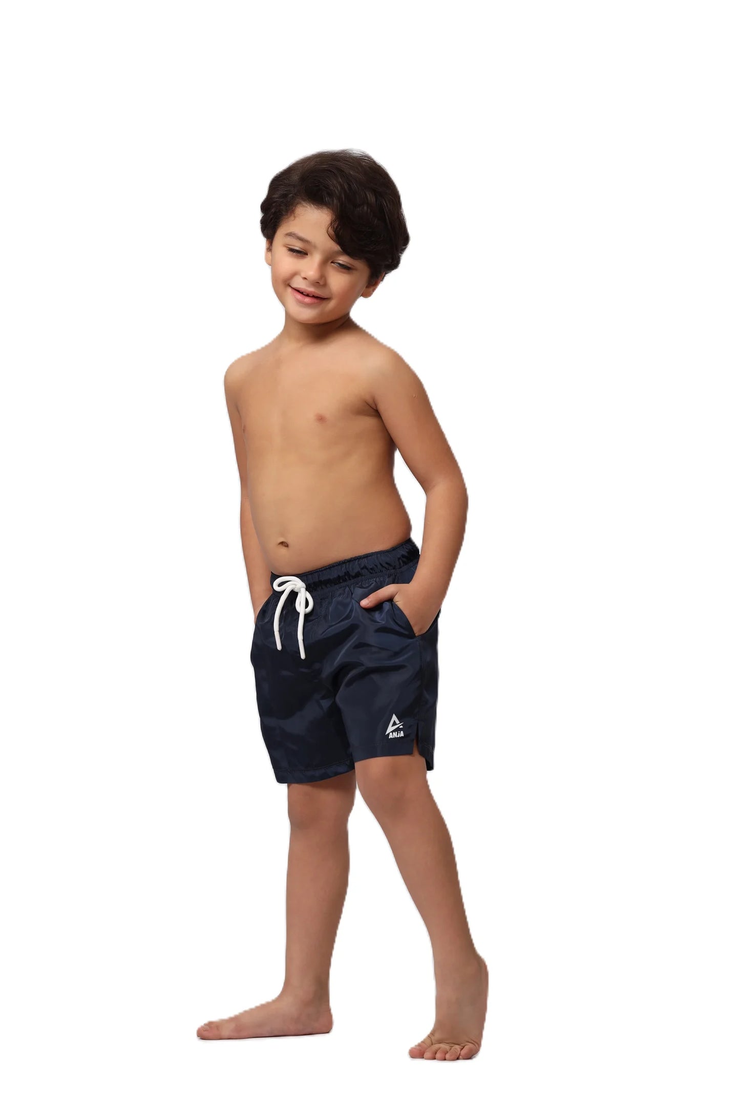 Child wearing navy blue swim shorts with a white logo on a white background