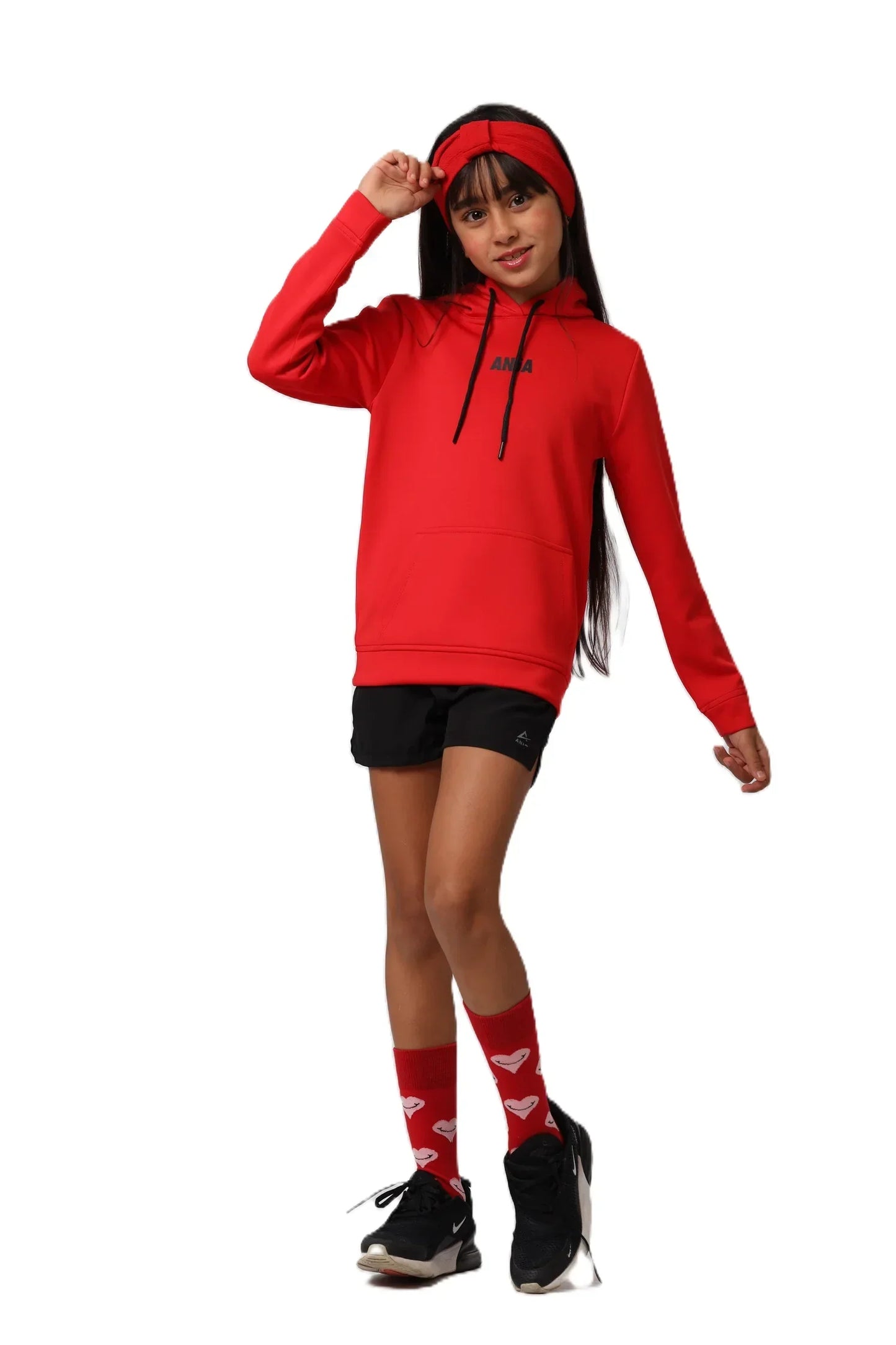 Person wearing a red hoodie, black shorts, and red socks with white hearts on a white background