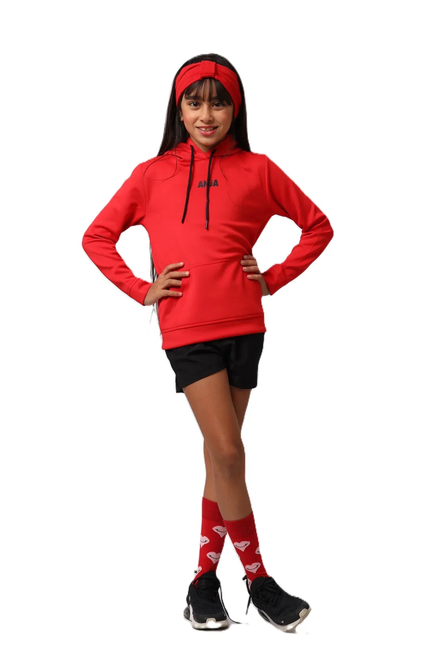 Person wearing a red hoodie, black shorts, and red socks with white hearts on a white background