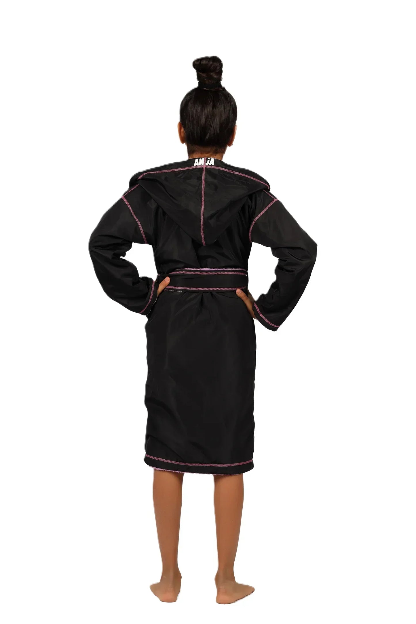 Person wearing a black robe with red trim on a white background