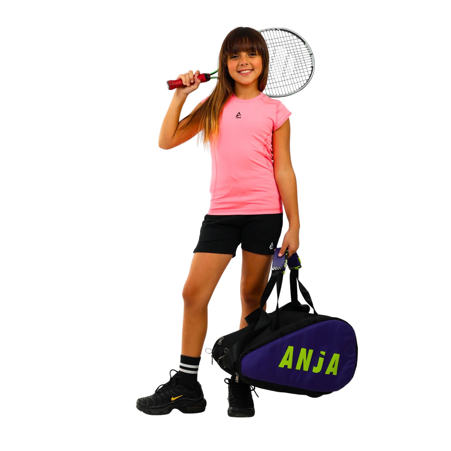 Girl holding a tennis racket and bag with 'Anja' branding on a white background