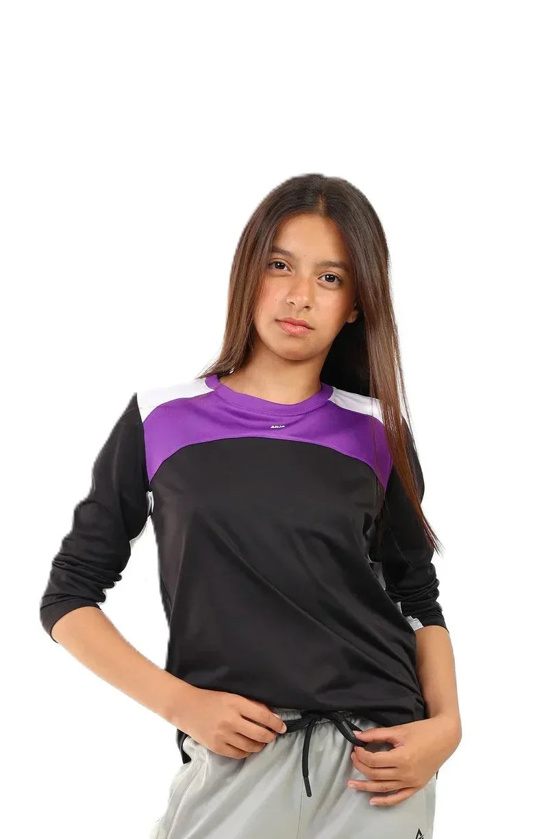 Young girl wearing a black and purple long-sleeve shirt on a white background