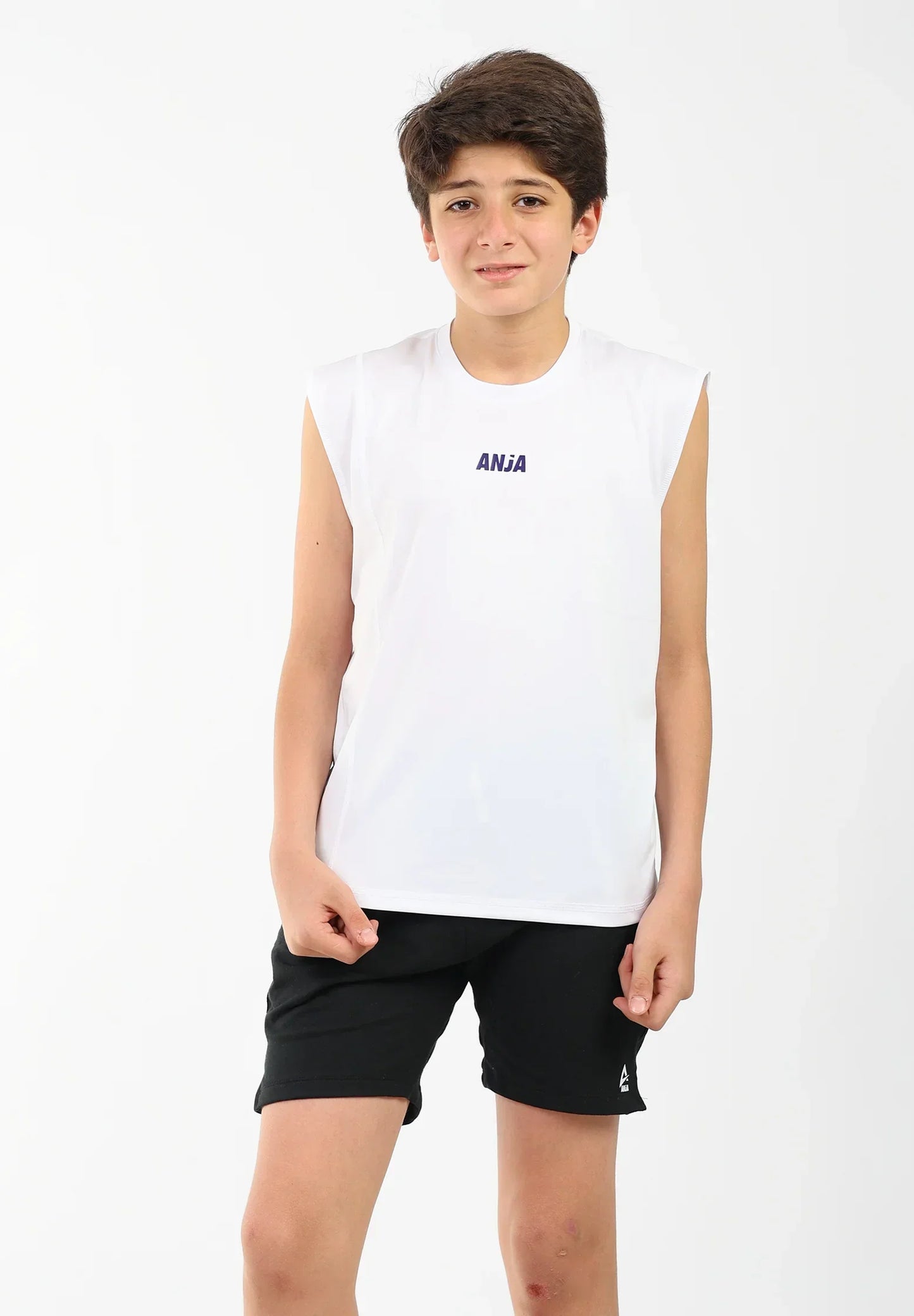 Young person wearing a white sleeveless shirt with 'ANIA' branding and black shorts on a white background