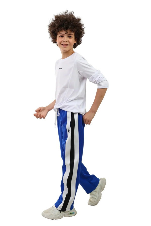 Child wearing a white shirt and blue pants with black stripes on a white background