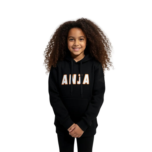 Child wearing a black hoodie with 'ANJA' printed on it against a white background
