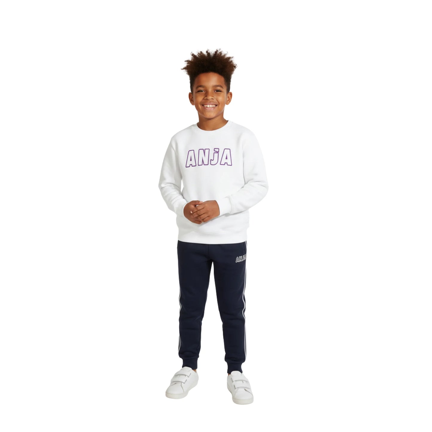 Child wearing a white sweatshirt with 'ANJA' branding and navy tracksuit pants on a white background