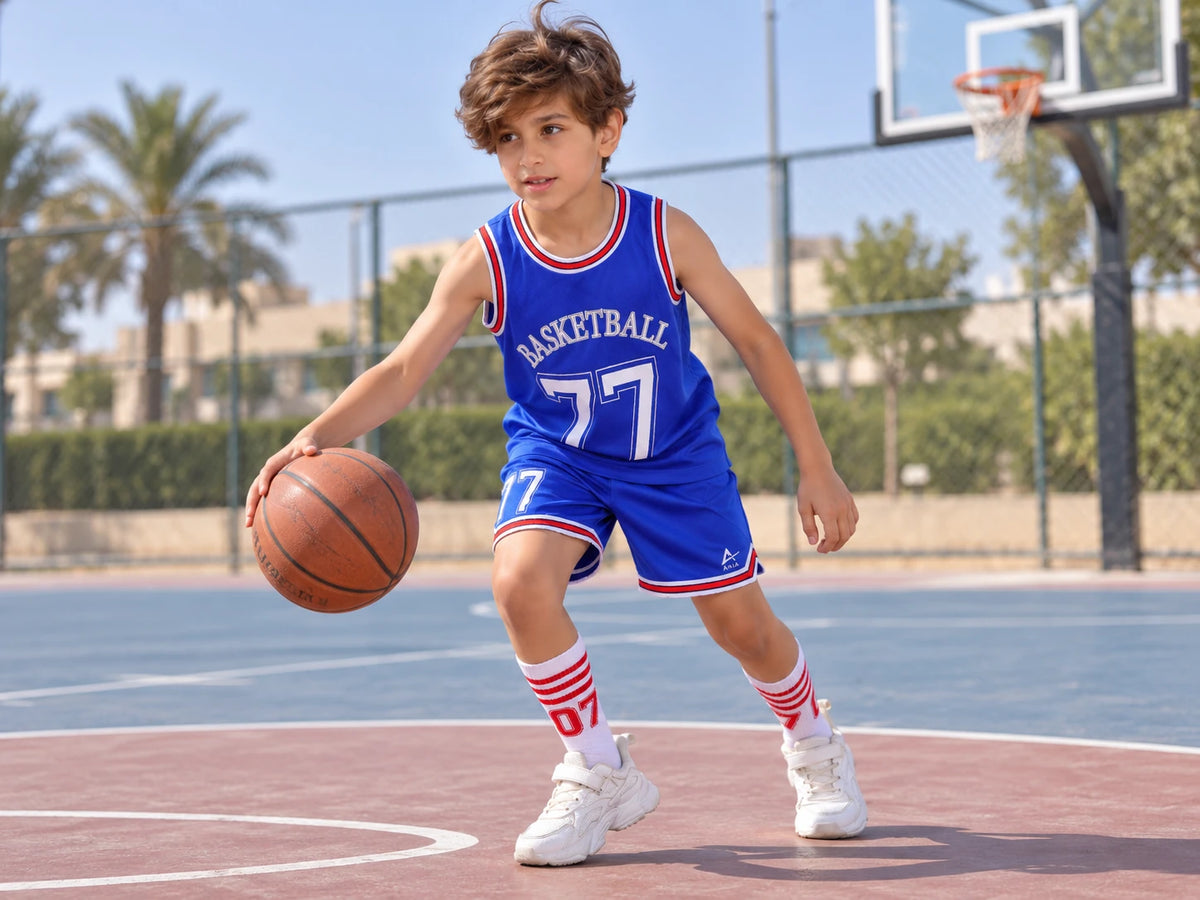 Boy dribbling a basketball in the ANJA blue basketball kit